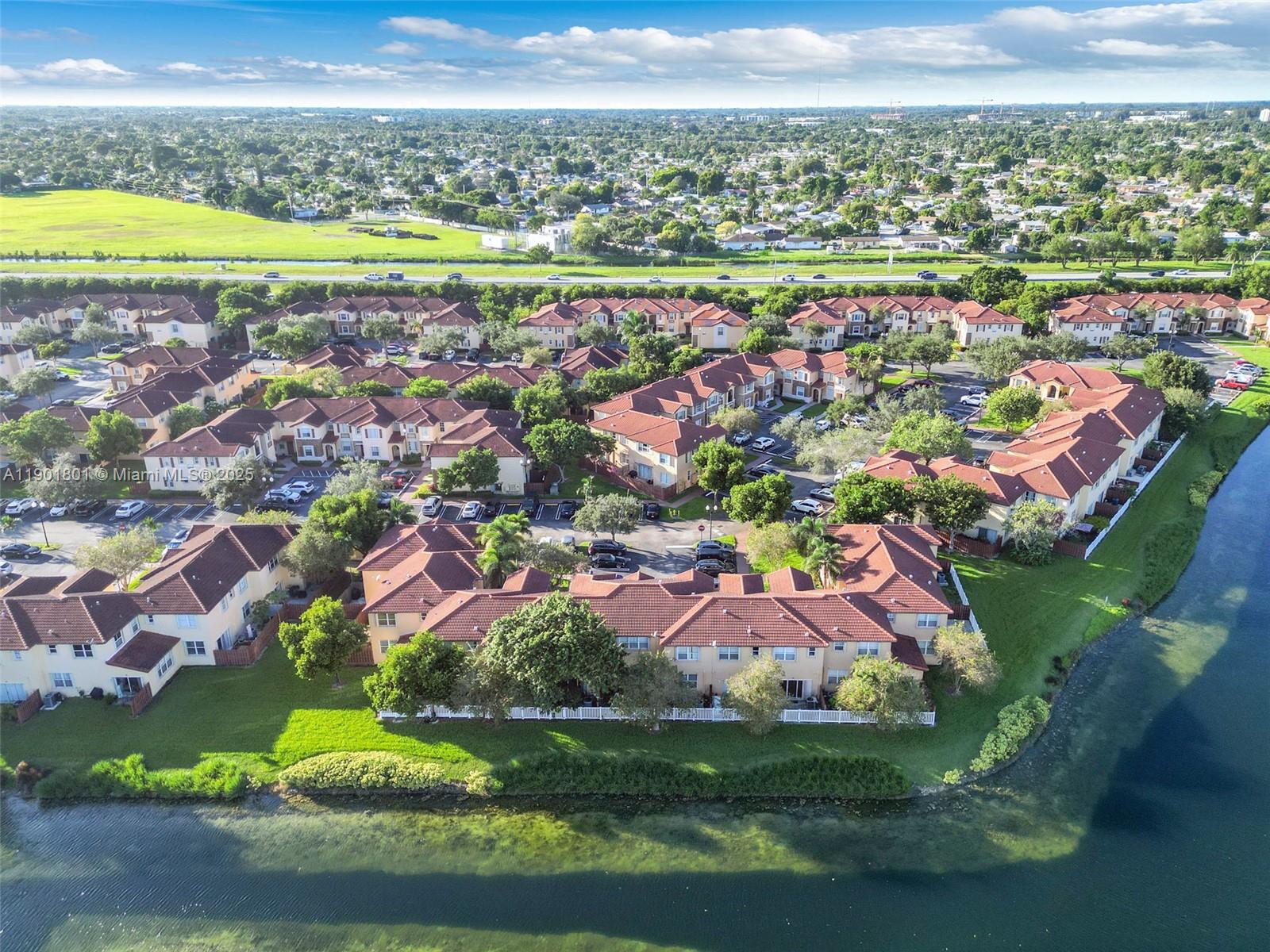 1595 Northeast 33rd Road, Unit 1123 Homestead, FL 33033 - Photo 30 of 34 an aerial view of residential houses with outdoor space and swimming pool