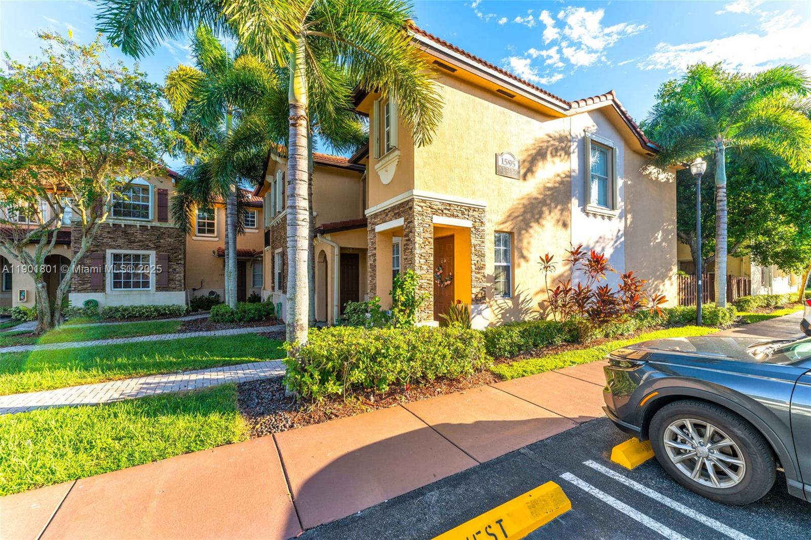 1595 Northeast 33rd Road, Unit 1123 Homestead, FL 33033 - Photo 3 of 34 a front view of a house with garden
