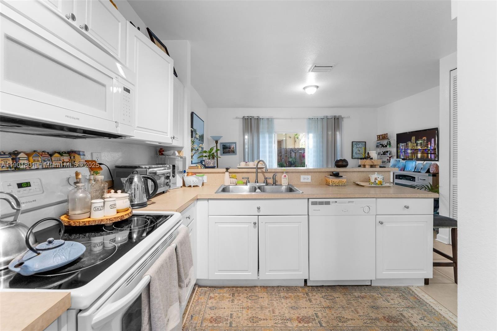 1595 Northeast 33rd Road, Unit 1123 Homestead, FL 33033 - Photo 6 of 34 a kitchen with a sink and cabinets