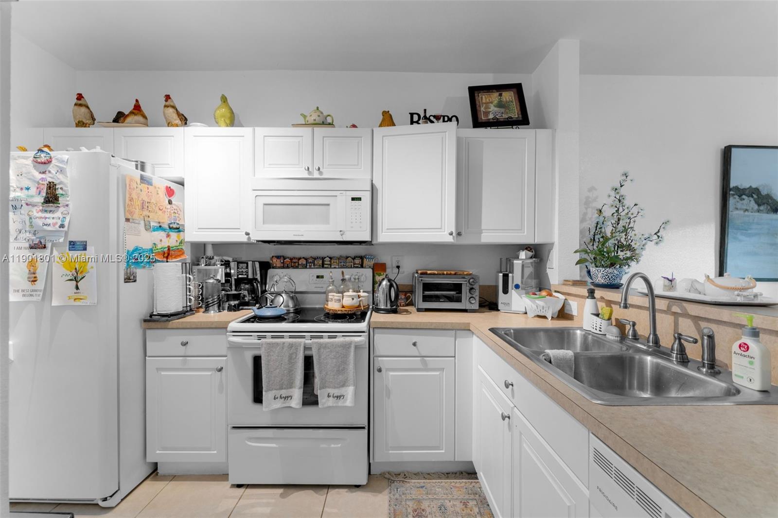 1595 Northeast 33rd Road, Unit 1123 Homestead, FL 33033 - Photo 8 of 34 a kitchen with stainless steel appliances granite countertop a sink stove and refrigerator