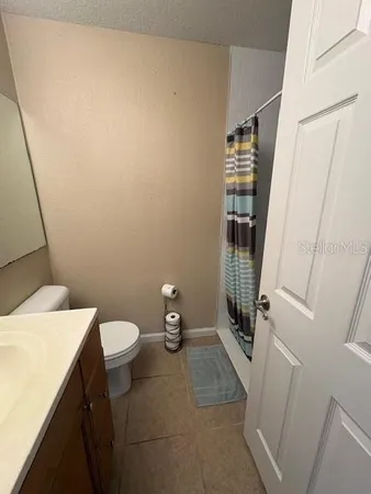 a bedroom with a bed and painting on the wall