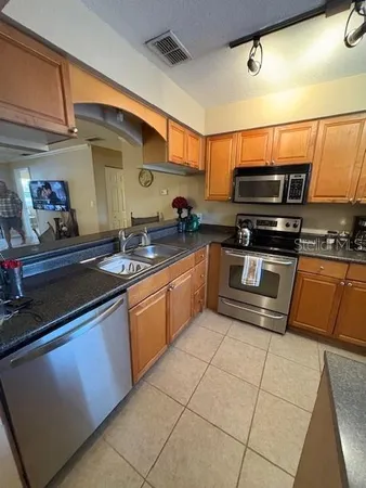 a kitchen with stainless steel appliances granite countertop a sink and cabinets