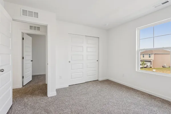 a living room with furniture flat screen tv and a window