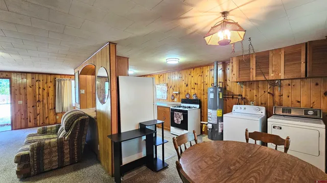 a living room with furniture a fireplace and a chandelier