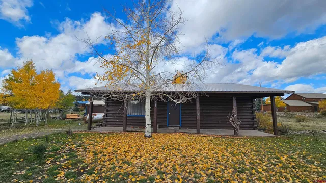 a backyard of a house with barbeque oven and outdoor seating