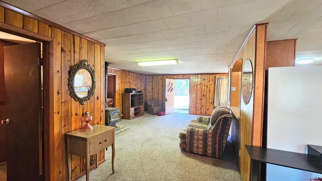 a living room with furniture a table and large window
