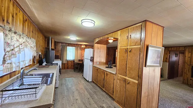 a hallway with wooden floor and furniture