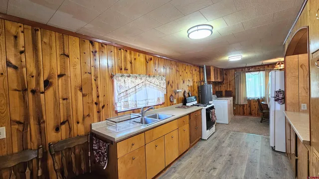 a large kitchen with a large window and stainless steel appliances