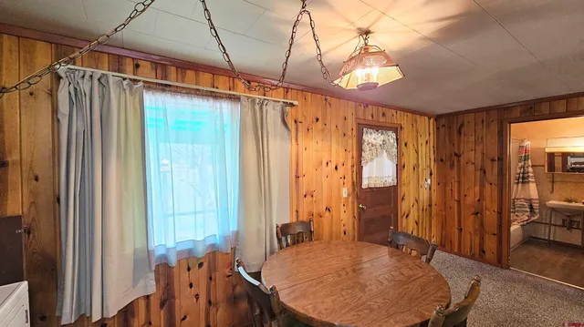 a very nice looking room with a large window and chandelier
