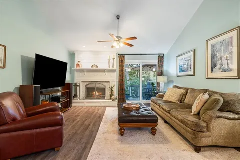 a living room with fireplace furniture and a flat screen tv