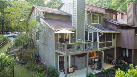 a view of a house with brick walls and potted plants