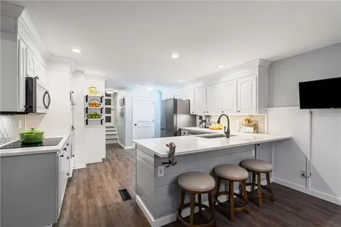 a living room with large window and a flat screen tv