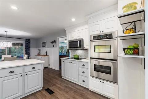 a dining room with furniture a rug and wooden floor