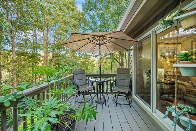 a bedroom with a bed a couch and a large window