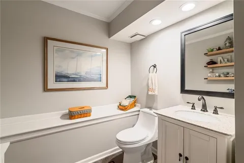 a bathroom with a toilet a sink and glass door