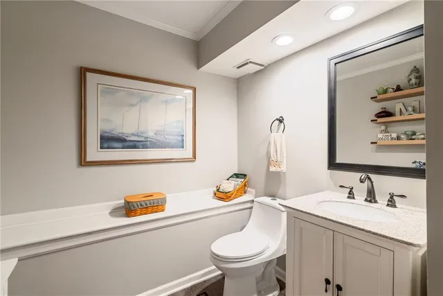 a bathroom with a toilet a sink and glass door