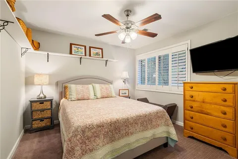 a bathroom with a granite countertop toilet a sink and a mirror