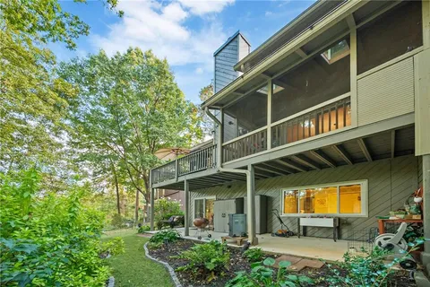 a kitchen with stainless steel appliances granite countertop a table chairs sink refrigerator and cabinets