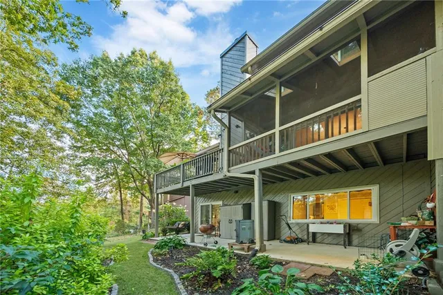a kitchen with stainless steel appliances granite countertop a table chairs sink refrigerator and cabinets