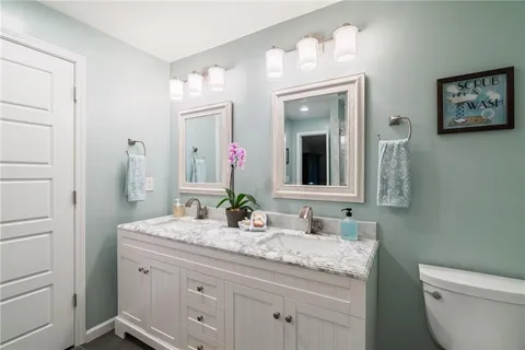 a view of a backyard with table and chairs potted plants and large tree