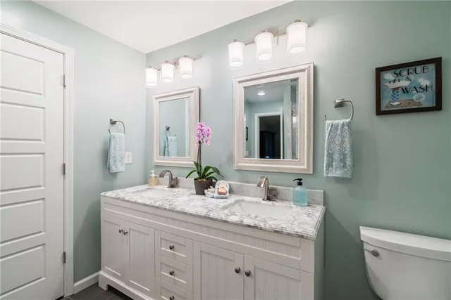 a view of a backyard with table and chairs potted plants and large tree
