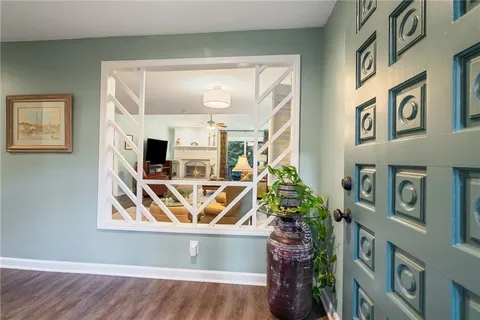 a living room with furniture a rug and wall painting