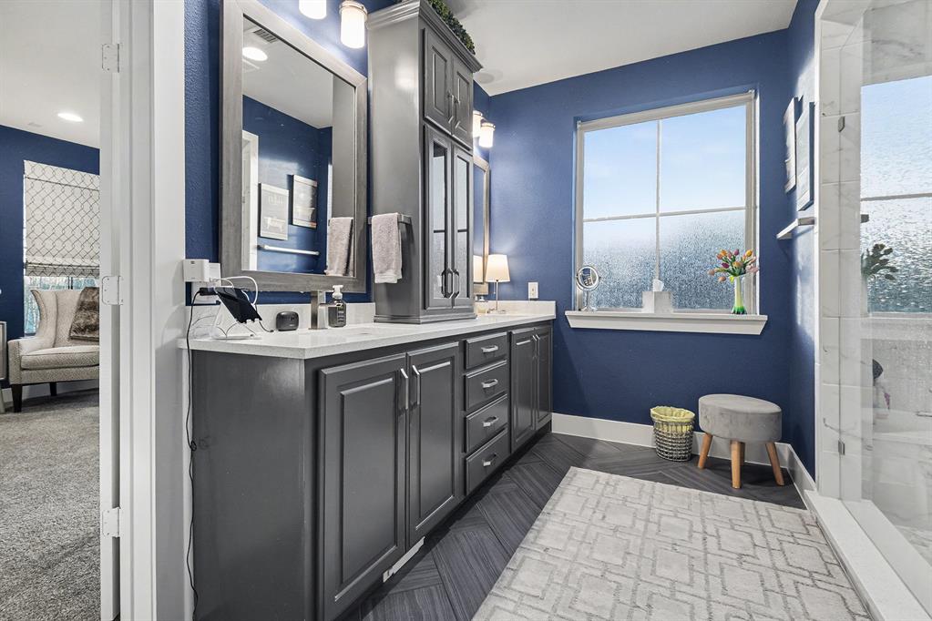 7011 Mistflower Ln. Dallas, TX 75231 - Photo 11 of 22 a en suite bathroom with a double vanity sink a mirror and a