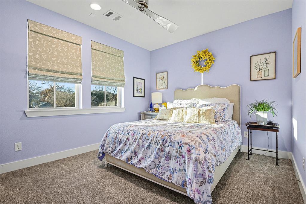 7011 Mistflower Ln. Dallas, TX 75231 - Photo 13 of 22 a bedroom with a bed and a table