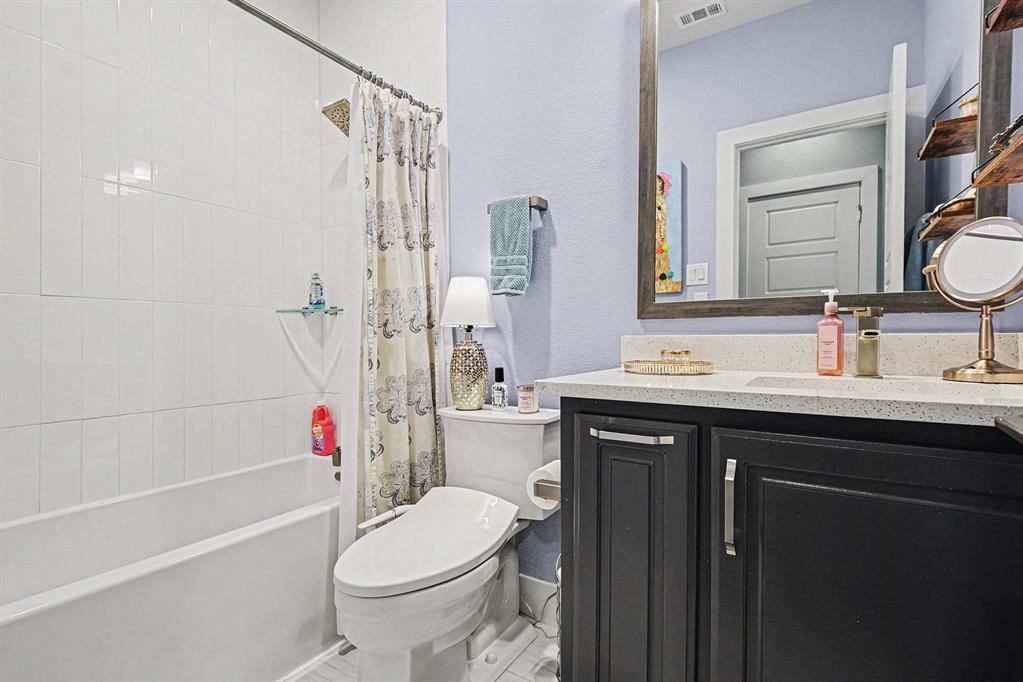 7011 Mistflower Ln. Dallas, TX 75231 - Photo 14 of 22 a bathroom with a sink a toilet and shower