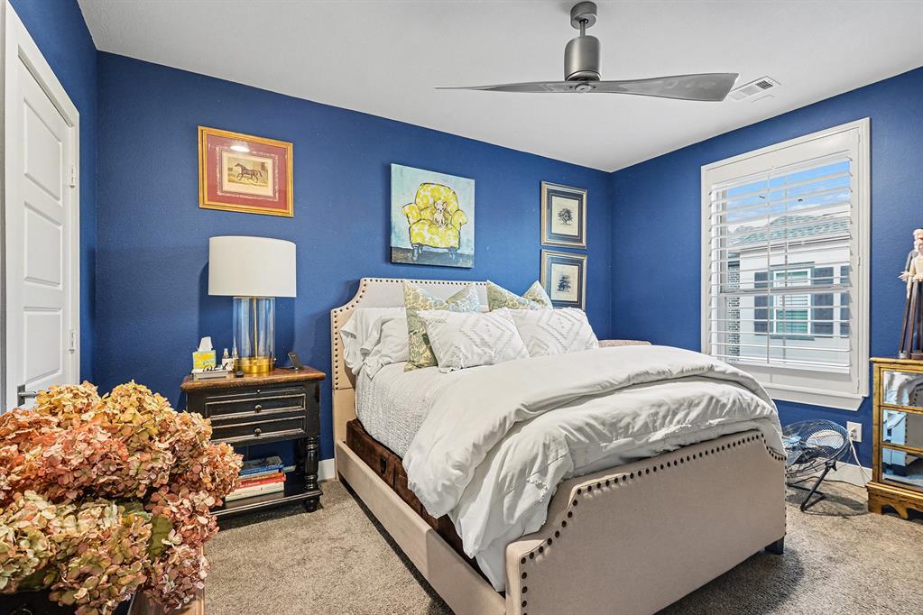 7011 Mistflower Ln. Dallas, TX 75231 - Photo 15 of 22 a bedroom with a bed and a table