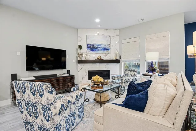 a living room with furniture fireplace and a flat screen tv