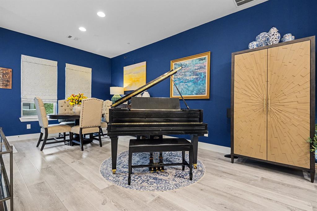 7011 Mistflower Ln. Dallas, TX 75231 - Photo 5 of 22 a living room with furniture a piano and a bookshelf