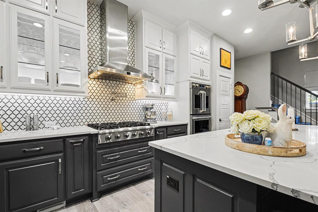7011 Mistflower Ln. Dallas, TX 75231 - Photo 6 of 22 a kitchen with a sink cabinets and stainless steel appliances