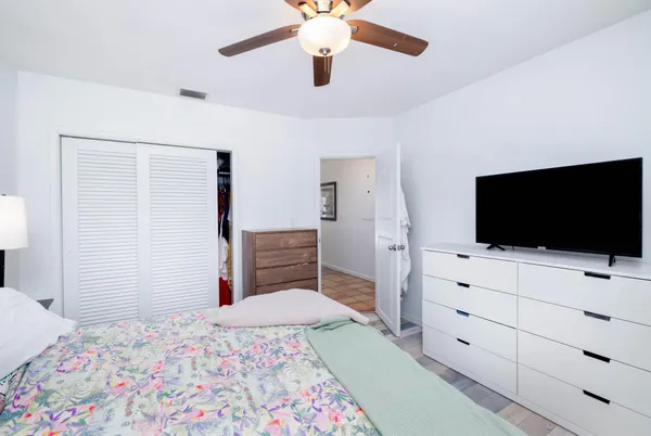 a bathroom with a granite countertop sink a toilet and shower