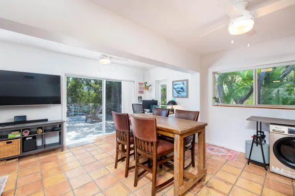 a roof deck with a table and chairs with wooden fence