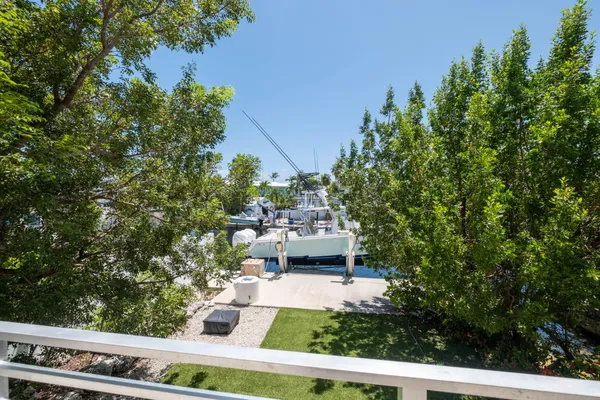 a view of house with yard and sitting area