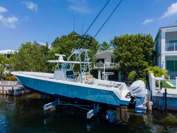 a view of a city with lawn chairs under an umbrella