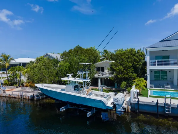 a front view of a house with a yard outdoor seating and a tree