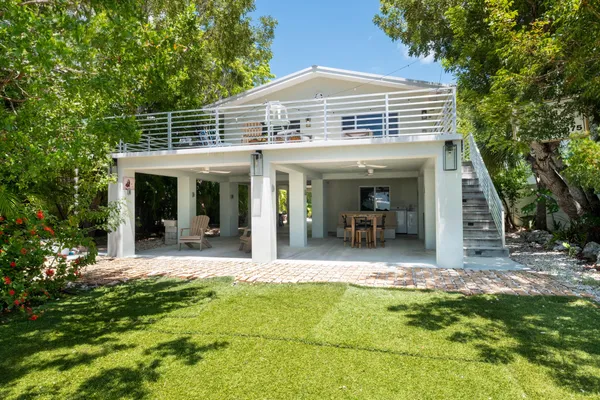 a living room with furniture a dining table and a potted plant