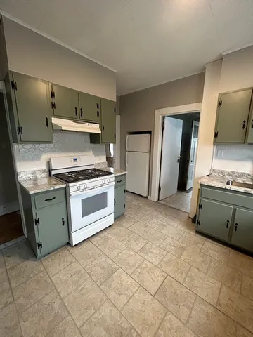 a kitchen with a stove and a sink