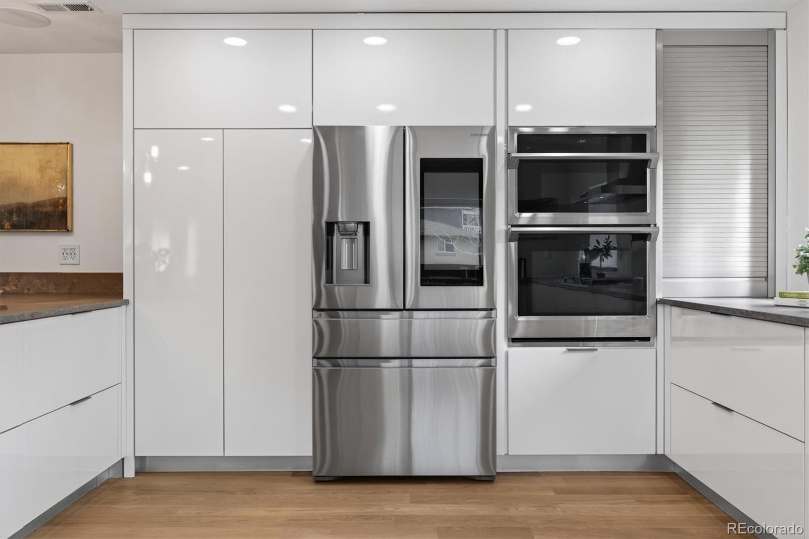 765 Kearney Street Denver, CO 80220 - Photo 12 of 35 a metallic refrigerator freezer sitting in a kitchen