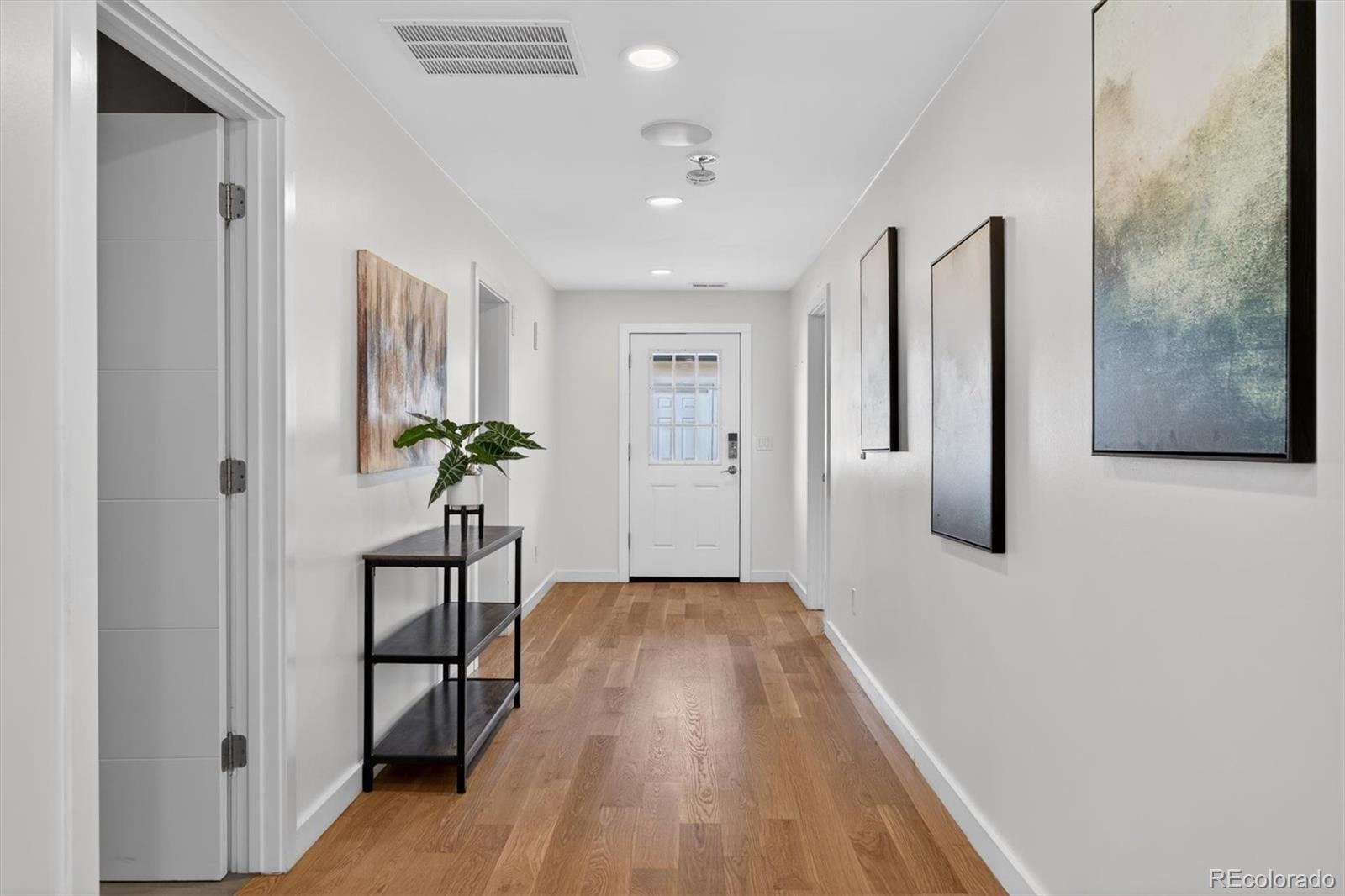765 Kearney Street Denver, CO 80220 - Photo 18 of 35 a view of a hallway with wooden floor and a potted plant