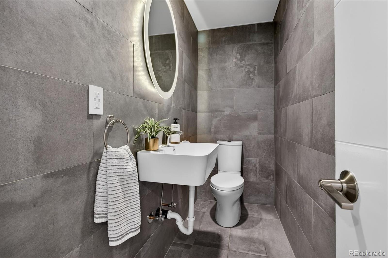 765 Kearney Street Denver, CO 80220 - Photo 20 of 35 a bathroom with a sink toilet and a mirror