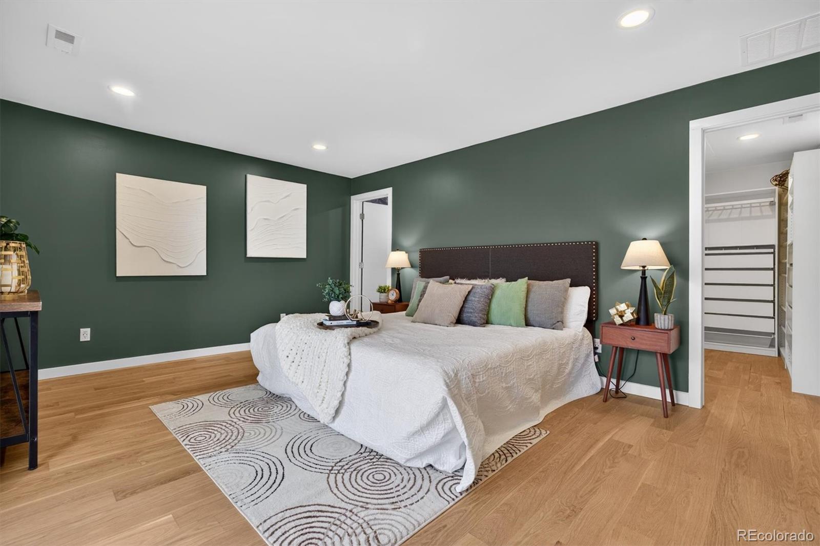 765 Kearney Street Denver, CO 80220 - Photo 21 of 35 a spacious bedroom with a bed and painting on the wall