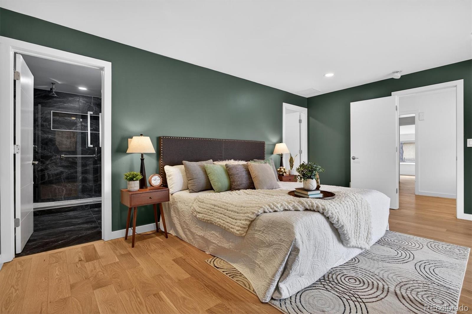 765 Kearney Street Denver, CO 80220 - Photo 23 of 35 a large bedroom with a bed and wooden floor