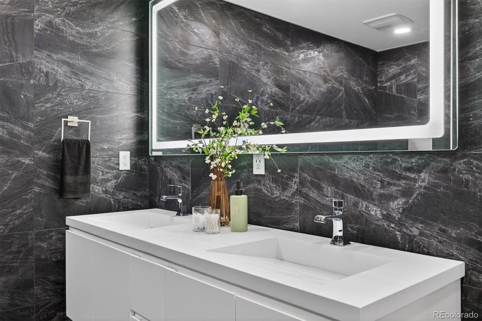 765 Kearney Street Denver, CO 80220 - Photo 25 of 35 a bathroom with a sink and a mirror