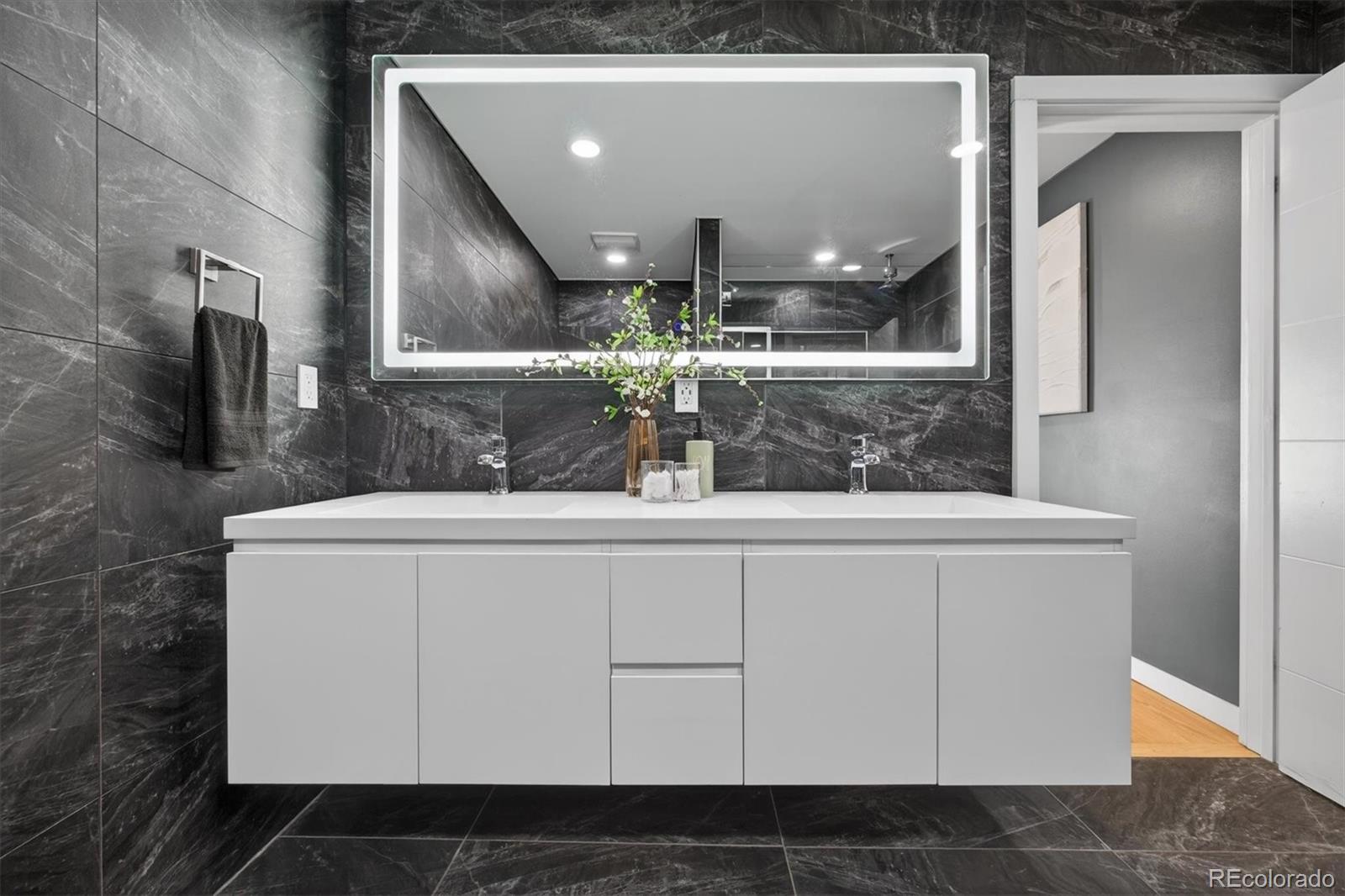 765 Kearney Street Denver, CO 80220 - Photo 26 of 35 a bathroom with a sink and a mirror