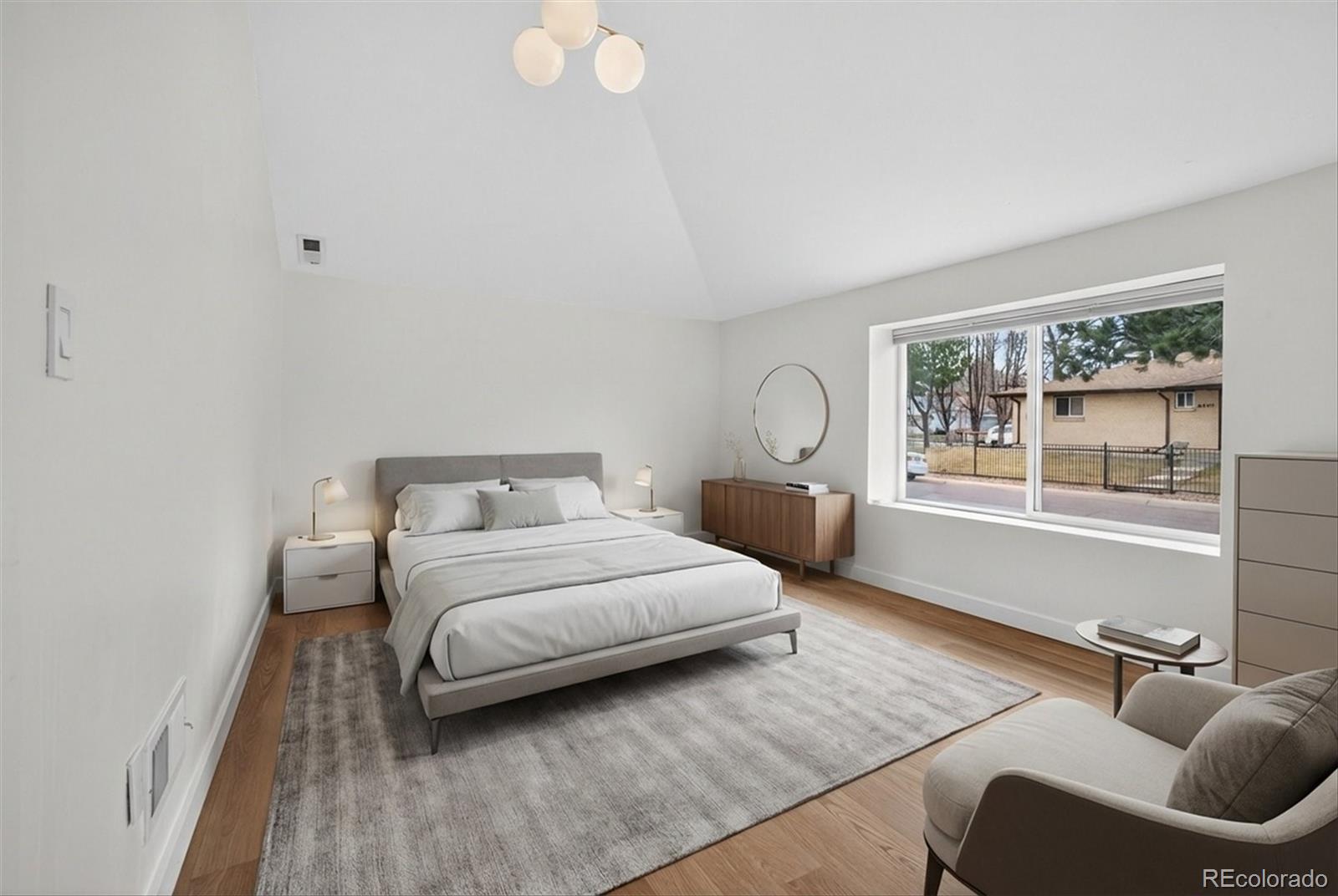 765 Kearney Street Denver, CO 80220 - Photo 28 of 35 a bedroom with a bed and wooden floor