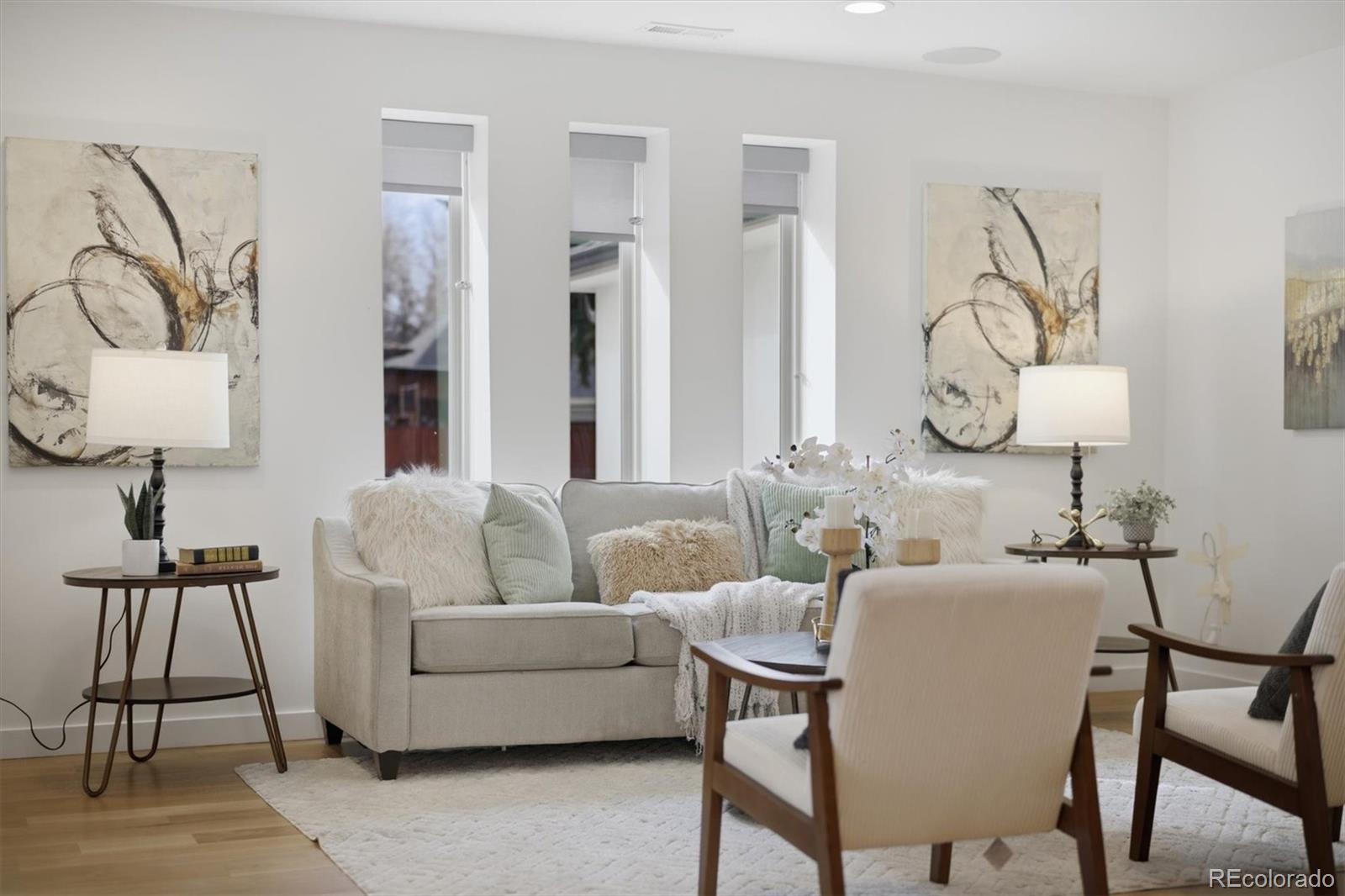 765 Kearney Street Denver, CO 80220 - Photo 5 of 35 a living room with furniture a wall clock and a lamp