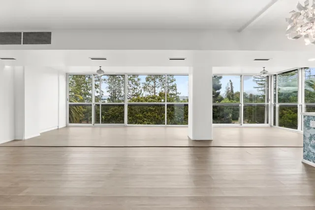 a view of an empty room with a large window